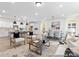 Open floor plan of the living room showcases a seamless transition to the modern kitchen and dining area at 13279 Arnold Palmer Cir # 867, Lancaster, SC 29720