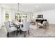 Open-concept space featuring a dining area and living area with modern furniture at 13279 Arnold Palmer Cir # 867, Lancaster, SC 29720