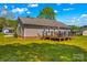 View of the backyard featuring a deck, wooden railings, grill, and steps to the yard at 140 Hazelwood Dr, Rockwell, NC 28138