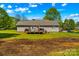 View of the backyard featuring the rear of the house, deck, and a large yard at 140 Hazelwood Dr, Rockwell, NC 28138