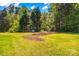 The backyard is mostly green grass with lots of trees at 140 Hazelwood Dr, Rockwell, NC 28138