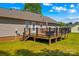 View of the backyard featuring a deck, wooden railings, grill, and steps to the yard at 140 Hazelwood Dr, Rockwell, NC 28138