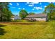 View of the backyard featuring the rear of the house, deck, and a large yard at 140 Hazelwood Dr, Rockwell, NC 28138