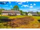View of the backyard featuring the rear of the house, deck, and a large yard at 140 Hazelwood Dr, Rockwell, NC 28138