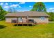 View of the backyard featuring a deck, wooden railings, grill, and steps to the yard at 140 Hazelwood Dr, Rockwell, NC 28138