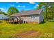 View of the backyard featuring a deck, wooden railings, grill, and steps to the yard at 140 Hazelwood Dr, Rockwell, NC 28138