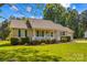 Attractive ranch-style home featuring a covered front porch and lush green lawn at 140 Hazelwood Dr, Rockwell, NC 28138