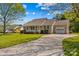 Inviting single-story home with a spacious driveway leading to an attached single-car garage at 140 Hazelwood Dr, Rockwell, NC 28138
