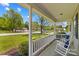 View from a relaxing front porch with classic rocking chairs and a neighborhood view at 140 Hazelwood Dr, Rockwell, NC 28138