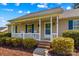 Close up of a charming front porch with blue shutters and inviting rocking chairs at 140 Hazelwood Dr, Rockwell, NC 28138