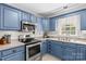 Updated kitchen with stainless steel appliances and blue cabinets at 140 Hazelwood Dr, Rockwell, NC 28138
