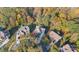 Aerial view of homes surrounded by beautiful fall foliage and mature trees creating a private and serene setting at 14010 Promenade Dr, Huntersville, NC 28078