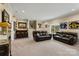 Spacious basement game room features a bar, popcorn machine, and comfortable leather sofas at 14010 Promenade Dr, Huntersville, NC 28078