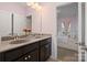 Well-lit bathroom featuring dual sinks and a peek into the bedroom at 14010 Promenade Dr, Huntersville, NC 28078