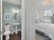 A peek into the bedroom from the bathroom, featuring a pedestal sink at 14010 Promenade Dr, Huntersville, NC 28078