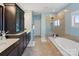 Bathroom with separate tub and walk-in shower at 14010 Promenade Dr, Huntersville, NC 28078