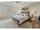 Serene main bedroom showcasing a large bed, warm tones, a ceiling fan, and lots of natural light at 14010 Promenade Dr, Huntersville, NC 28078