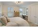 Cozy bedroom with natural light, neutral tones, and a functional workstation at 14010 Promenade Dr, Huntersville, NC 28078
