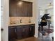 Elegant butler's pantry featuring custom cabinets, granite countertop, wine storage, and convenient access to the living room at 14010 Promenade Dr, Huntersville, NC 28078