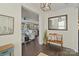 Welcoming foyer with hardwood floors, bench seating, decorative mirror, and an open view to the living area at 14010 Promenade Dr, Huntersville, NC 28078