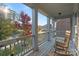 Inviting front porch with classic rocking chairs, white pillars, and a serene view of the neighborhood at 14010 Promenade Dr, Huntersville, NC 28078
