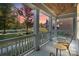 Inviting front porch with cozy seating offering a tranquil neighborhood view at 14010 Promenade Dr, Huntersville, NC 28078