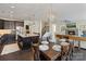 Open-concept kitchen and dining area with a large island and modern lighting at 14010 Promenade Dr, Huntersville, NC 28078