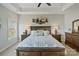Spacious main bedroom with tray ceiling, decorative wall art, and wooden furniture at 14010 Promenade Dr, Huntersville, NC 28078