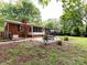 Large backyard with a patio, screened-in porch, and mature trees at 1408 Wicker Dr, Charlotte, NC 28210