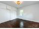 Bright bedroom with hardwood floors, built-in storage, and a window at 1408 Wicker Dr, Charlotte, NC 28210