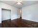 Bedroom with hardwood floors, built-in storage, and neutral paint at 1408 Wicker Dr, Charlotte, NC 28210