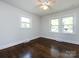 Light-filled bedroom with hardwood floors and dual windows at 1408 Wicker Dr, Charlotte, NC 28210