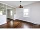 Dining room with refinished hardwood floors and neutral paint with built-in shelves at 1408 Wicker Dr, Charlotte, NC 28210