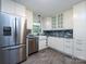 Renovated kitchen featuring stainless steel appliances, gray countertops, and tile floors at 1408 Wicker Dr, Charlotte, NC 28210