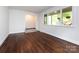 Bright living room with refinished hardwood floors, natural light, and neutral paint at 1408 Wicker Dr, Charlotte, NC 28210
