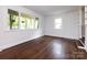 Bright living room with refinished hardwood floors, natural light, and neutral paint at 1408 Wicker Dr, Charlotte, NC 28210