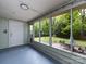Enclosed sunroom with views of the private backyard and patio seating area at 1408 Wicker Dr, Charlotte, NC 28210