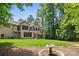 Expansive backyard featuring a lush green lawn and mature trees, perfect for outdoor enjoyment and relaxation at 14130 Lea Point Ct, Huntersville, NC 28078