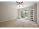 Spacious bedroom featuring neutral walls, plush carpet, ceiling fan, and a sunlit window at 14130 Lea Point Ct, Huntersville, NC 28078