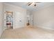 Bedroom features two access doors, plush carpet, and white trim against neutral walls at 14130 Lea Point Ct, Huntersville, NC 28078