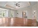 Spacious bedroom with hardwood floors, tray ceiling, natural light, and an en-suite bathroom at 14130 Lea Point Ct, Huntersville, NC 28078