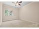 Neutral carpet in bedroom with neutral walls, white trim and natural light at 14130 Lea Point Ct, Huntersville, NC 28078