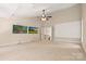 Large bonus room with two televisions, a ceiling fan, and access to the staircase at 14130 Lea Point Ct, Huntersville, NC 28078