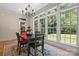 Sunlit breakfast nook with backyard views, an elegant chandelier, and seating for four at 14130 Lea Point Ct, Huntersville, NC 28078