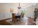 Elegant dining room showcases a modern chandelier, large window, and wainscoting details at 14130 Lea Point Ct, Huntersville, NC 28078