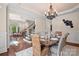 Formal dining room with a view to the homes stairway, living room, and large, decorative chandelier at 14130 Lea Point Ct, Huntersville, NC 28078