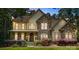 Inviting exterior view of the home, featuring stonework and warm lighting at 14130 Lea Point Ct, Huntersville, NC 28078