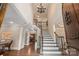 Grand foyer with a soaring ceiling, hardwood floors, and an elegant staircase at 14130 Lea Point Ct, Huntersville, NC 28078