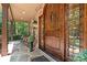 Covered front porch with stone columns, stylish seating, and a solid wood door at 14130 Lea Point Ct, Huntersville, NC 28078
