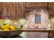 A warm kitchen featuring custom wood cabinets, granite countertops, and decorative tile backsplash at 14130 Lea Point Ct, Huntersville, NC 28078